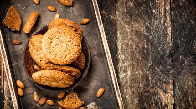 Oatmeal cookies with nuts. On a wooden background.