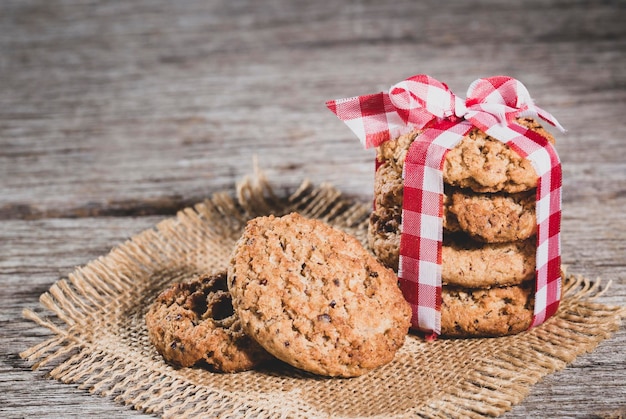 Oatmeal cookies on wooden background closeup