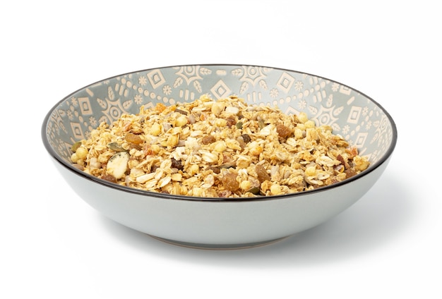 Oatmeal crunches with raisins, pumpkin seeds and sunflower seeds in a gray round ceramic plate on white background