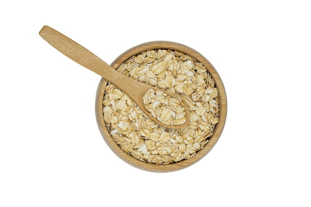 Photo oatmeal flakes in wooden bowl and spoon