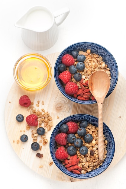 Oatmeal Granola with berries honey and milk Ingredients for healthy breakfast