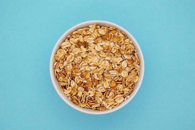 Oatmeal on the plate in blue background