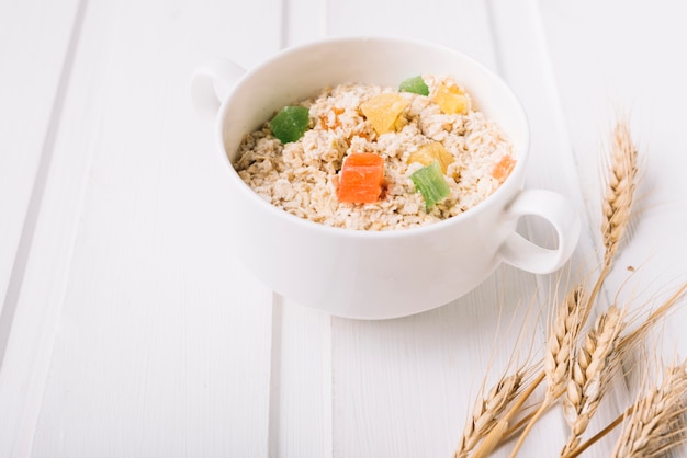 Oatmeal porridge in bowl topped with fresh jelly candies