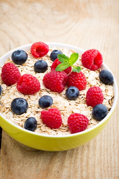 Oatmeal porridge with berries. Raspberries and blueberries.