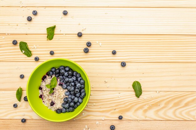 Oatmeal porridge with fresh blueberry, mint leaves and yogurt