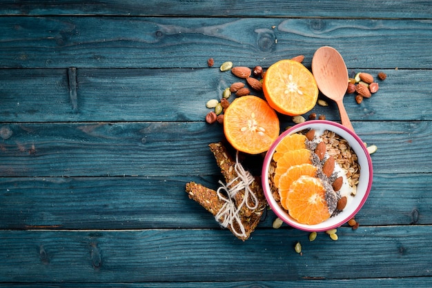 Oatmeal porridge with orange chia seeds and almonds Top view Free space for your text