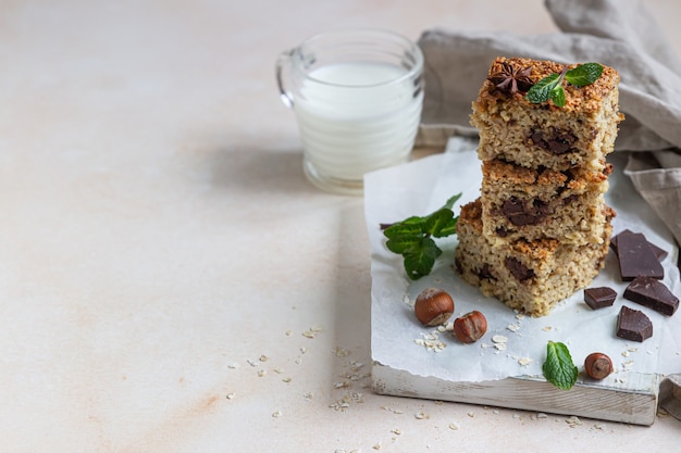 Oatmeal squares with chocolate and a cup of milk. Diet bars. Healthy breakfast or dessert.