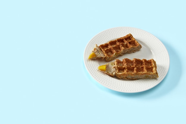 Oatmeal waffles in pencil shape on blue table