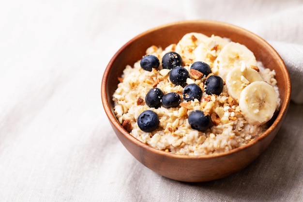 Oatmeal with bananas blueberries and almondsVegan food