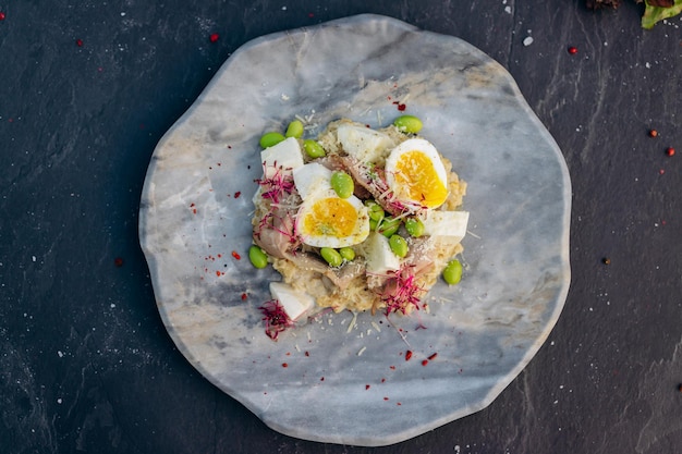 Oatmeal with boiled egg bacon and green peas Healthy and tasty breakfast