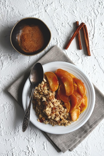 Oatmeal with caramelized apple and cinnamon on a plate Healthy breakfast Breakfast restaurant