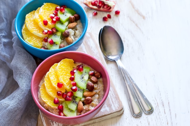 Oatmeal with fruit and nuts for a healthy breakfast. Top view with copy space