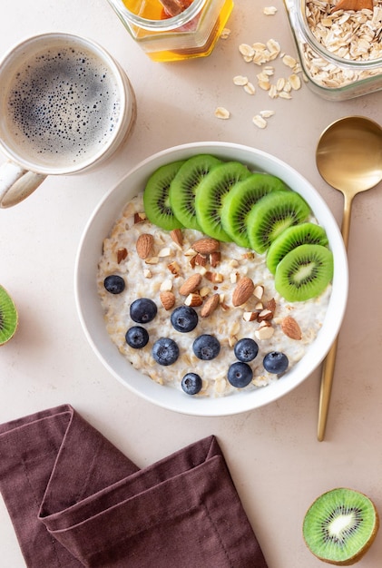 Oatmeal with kiwi blueberries almonds and honey Healthy food Vegetarian food Breakfast