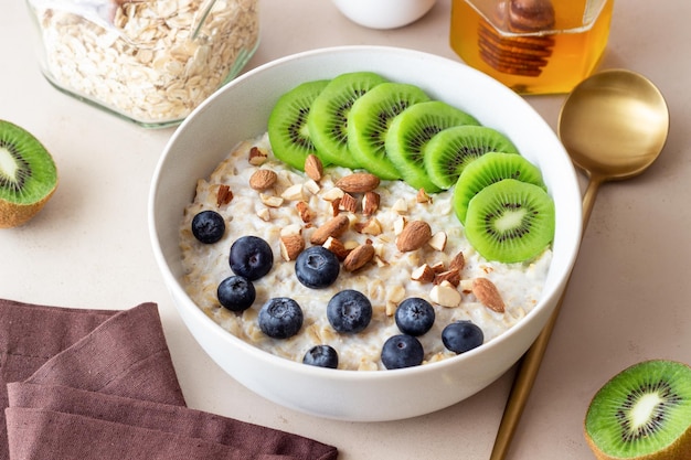 Oatmeal with kiwi blueberries almonds and honey Healthy food Vegetarian food Breakfast