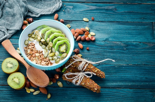 Oatmeal with kiwi and pumpkin seeds Top view Free space for your text