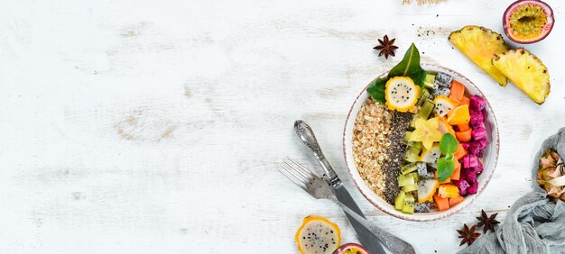 Oatmeal with tropical fruit Top view Free space for text