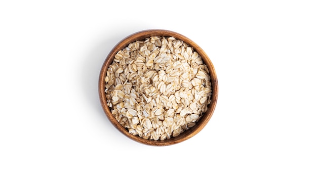 Photo oatmeal in a wooden bowl isolated on a white background. high quality photo