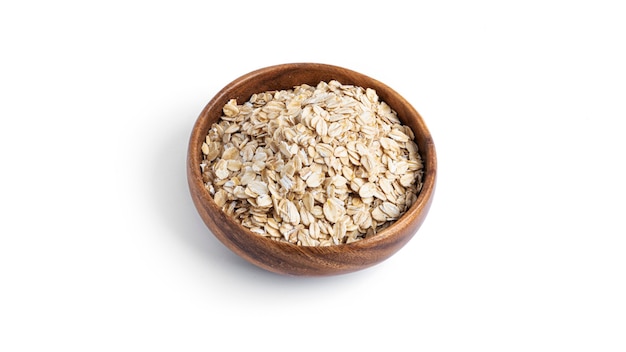 Oatmeal in a wooden bowl isolated on a white background. High quality photo