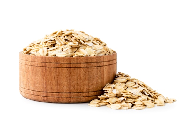 Oatmeal in a wooden plate on white