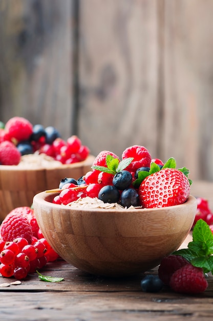 Oats with mix of berries on the wooden table