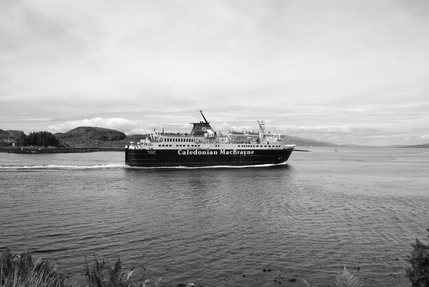 Oban United Kingdom February 20 2010 Holiday ship navigate along sea coast Cruise liner in sea Cruise destination and travel Summer vacation on island Marine travel Wanderlust and discovery