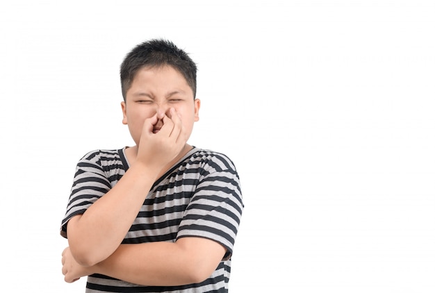 Obese boy holding his nose because of a bad smell