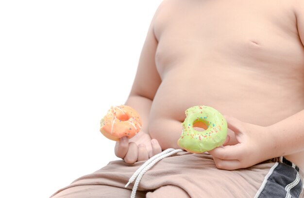 Obese fat boy is holding donut isolated 