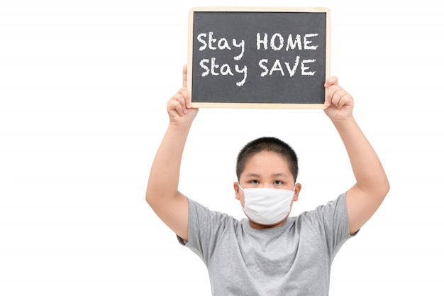 Obese fat boy wear mask shows blackboard with stay home stay save words