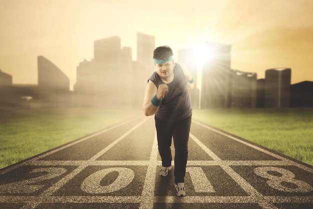 Obese man running on the track