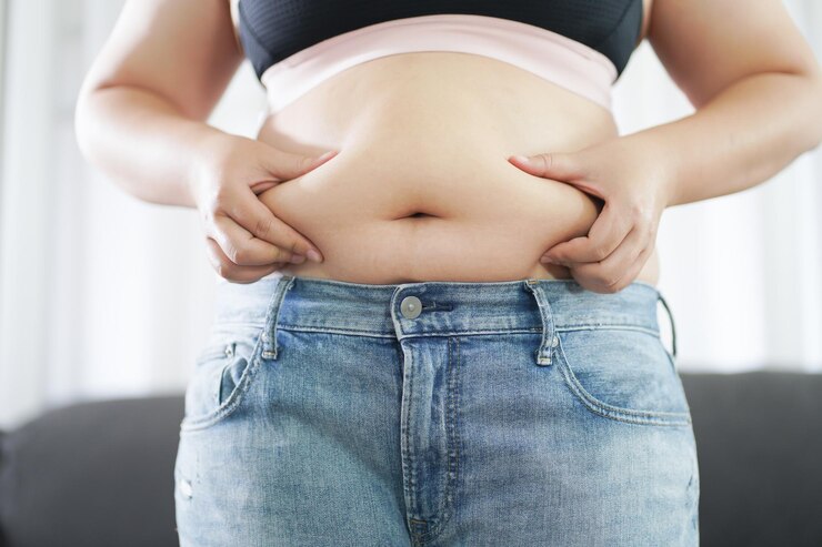 Photo obese woman with fat upset about her belly overweight woman touching his fat belly and want to lose weight fat woman with tight clothing worried about weight diet lifestyle concept