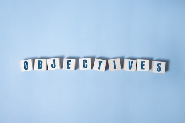 Objective word written on wood block. objective text on table, concept.