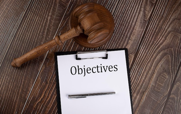 OBJECTIVES text on the paper with gavel on the wooden background