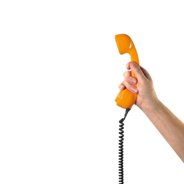 Objects Hands action Hand holds retro orange phone red handset Isolated