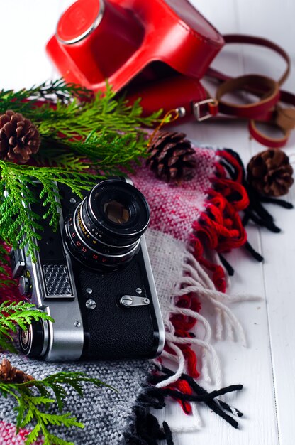 Objects top view lifestyle essentials of artist. Retro vintage film camera and a blanket.