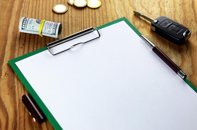 Objects on wooden table empty paper money and keys