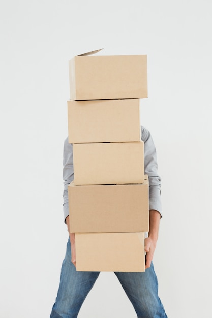 Obscured man carrying boxes