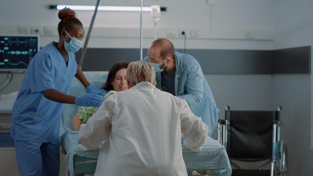 Obstetrics doctor and african american nurse delivering child