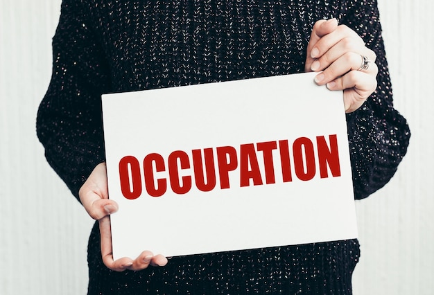 OCCUPATION word on a paper in woman hands