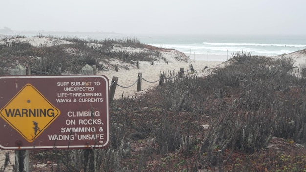 Ocean beach sandy dunes california misty coast foggy rainy weather cold sea