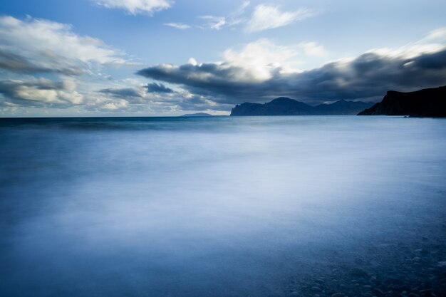 Ocean, clouds and rocky mountains