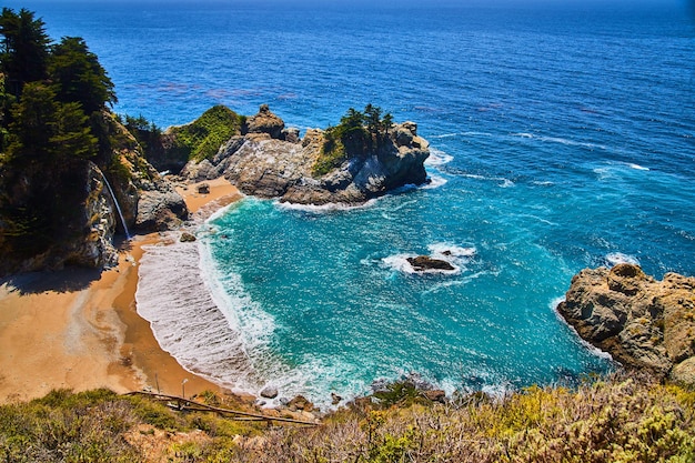 Ocean cove leads to sandy beaches and secret waterfall