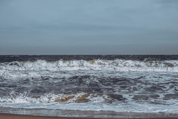 Ocean storm waves dramatically crashing splashing sky horizon
line sea water edge nature front view marine wallpaper design bad
weather cloudy overcast dark green turquoise blue tone pale
matte