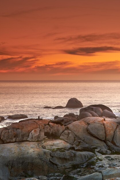 Photo ocean sunset and waves on rocks on tropical island and tourism destination for summer vacation in nature sky clouds and golden color on torrey pines beach peace and outdoor travel in california