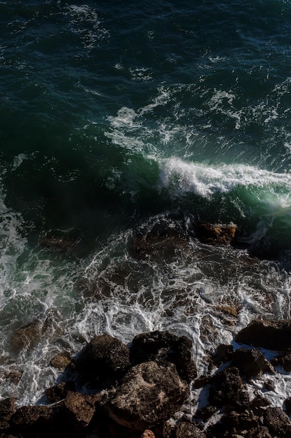 Ocean wave background breaking sea water rocky shore