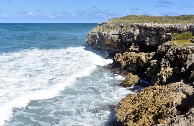 ocean waves are hitting the rocks