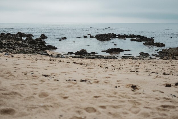 Ocean waves hitting the rocky and sandy beach