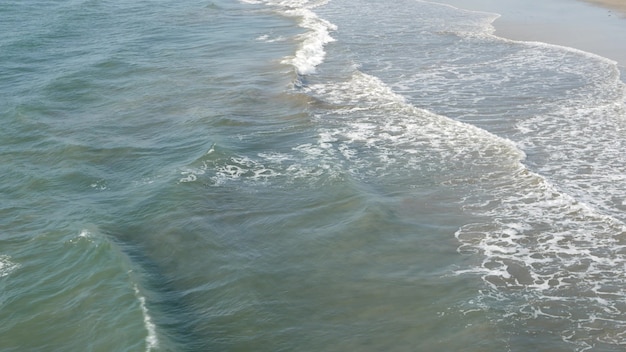 плещутся океанские волны, побережье Калифорнии, США. Вода морская пена. Морской пейзаж. Солнечный тропический летний день