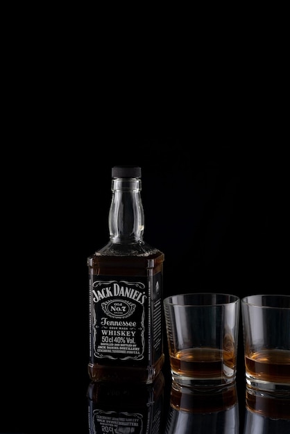 Photo october 2022 ukraine krivoy rog bottle of whiskey jack daniels on a black background