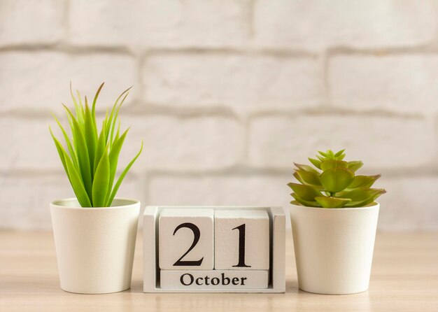 October 21 on the calendar on a light wooden backgroundDate of the autumn month