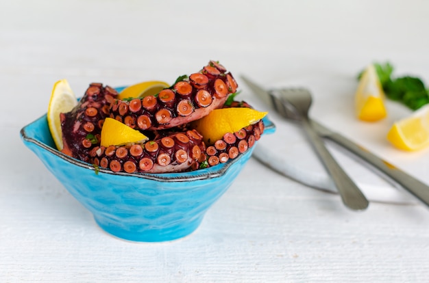 Octopus in a Blue Bowl on White Background